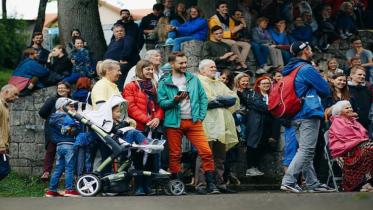 A crowd of people sitting and standing in the Conversation festival LAMPA in Cesis, Latvia