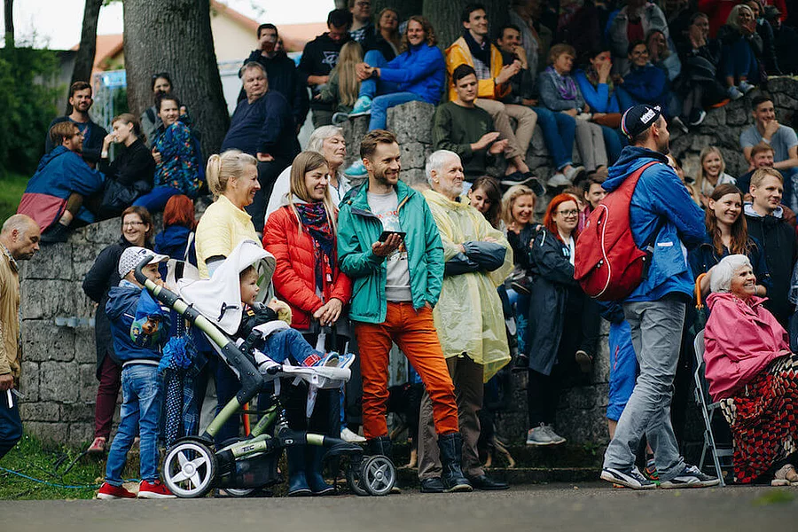 A crowd of people sitting and standing in the Conversation festival LAMPA in Cesis, Latvia